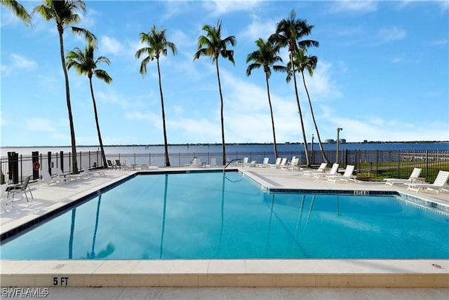 view of pool featuring a water view and a patio area