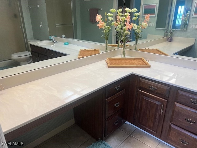 bathroom featuring vanity, toilet, and tile patterned flooring