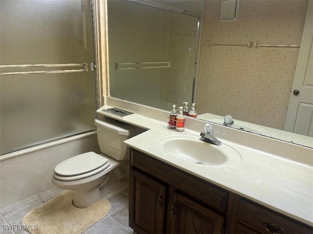 bathroom with tile patterned flooring, vanity, and toilet