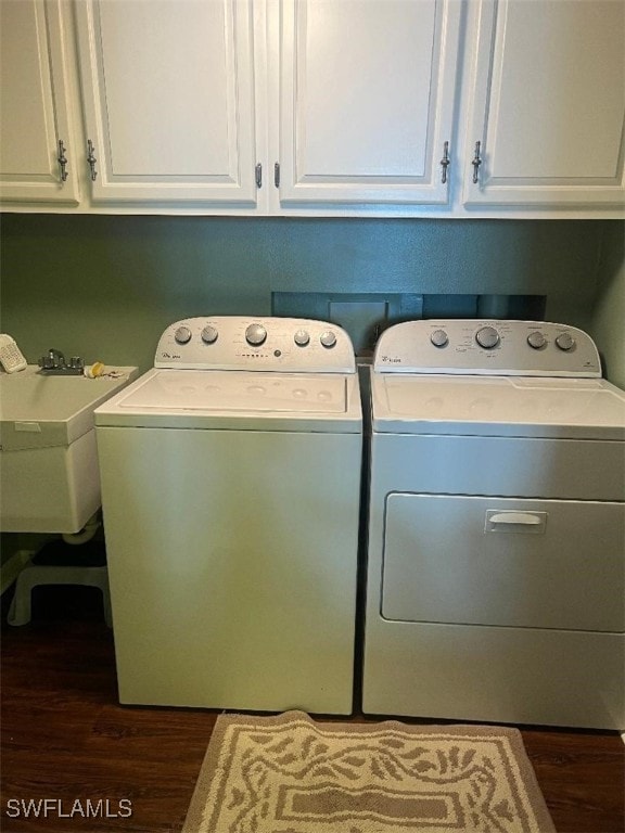 laundry room featuring cabinets, separate washer and dryer, dark hardwood / wood-style floors, and sink