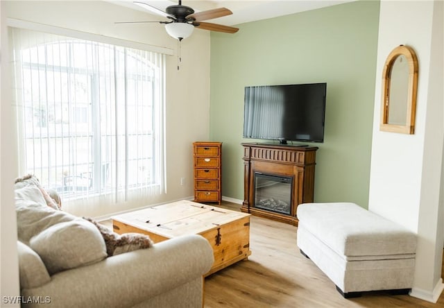 living room featuring hardwood / wood-style flooring, a wealth of natural light, and ceiling fan