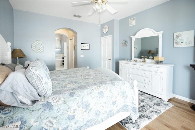 bedroom with connected bathroom, ceiling fan, and light wood-type flooring