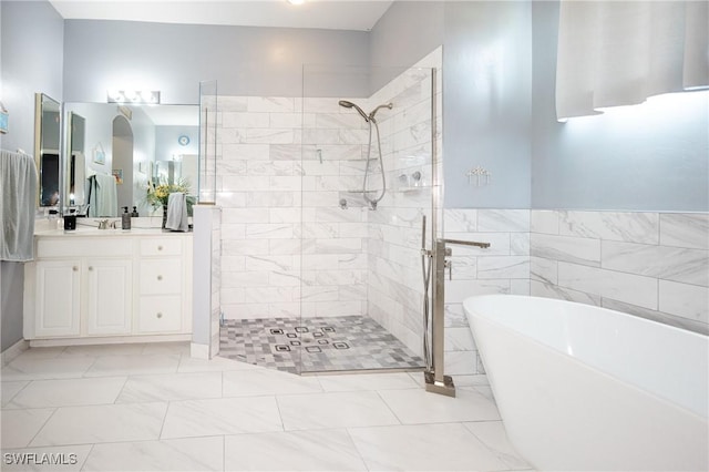 bathroom featuring vanity, independent shower and bath, and tile walls