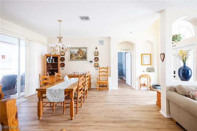 dining area featuring an inviting chandelier and light wood-type flooring