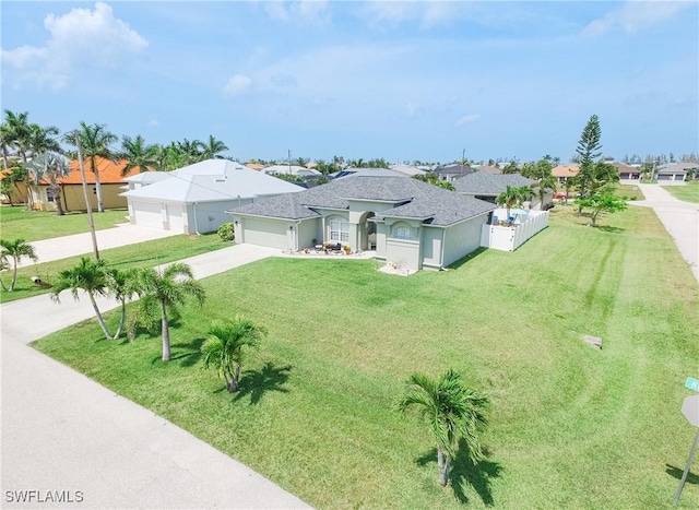 view of front of property featuring a garage and a front lawn