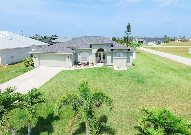 view of front of home featuring a garage and a front lawn