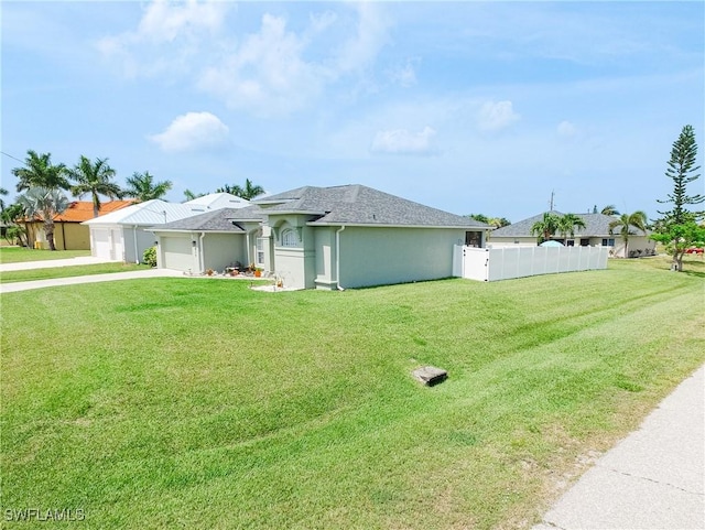 view of front of house with a garage and a front lawn