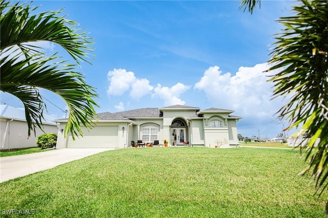 mediterranean / spanish-style house with a garage and a front lawn