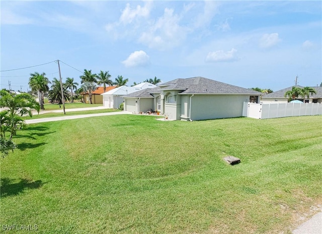 exterior space featuring a garage and a lawn