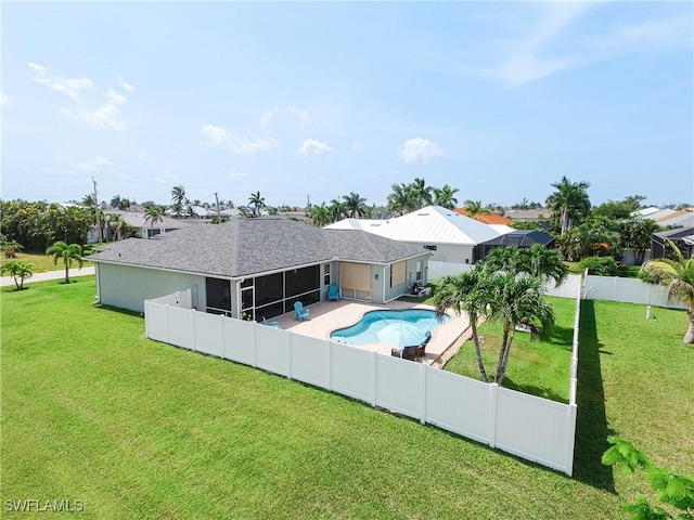 view of pool featuring a yard, a patio, and a sunroom