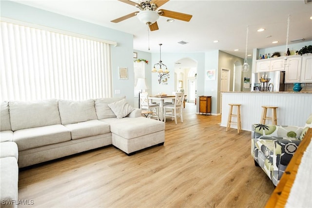 living room featuring ceiling fan and light wood-type flooring