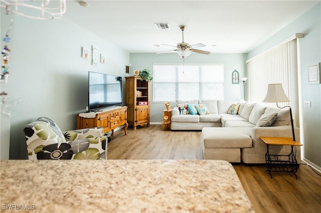 living room with ceiling fan and wood-type flooring