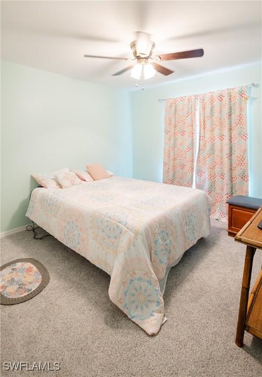 bedroom with ceiling fan and carpet