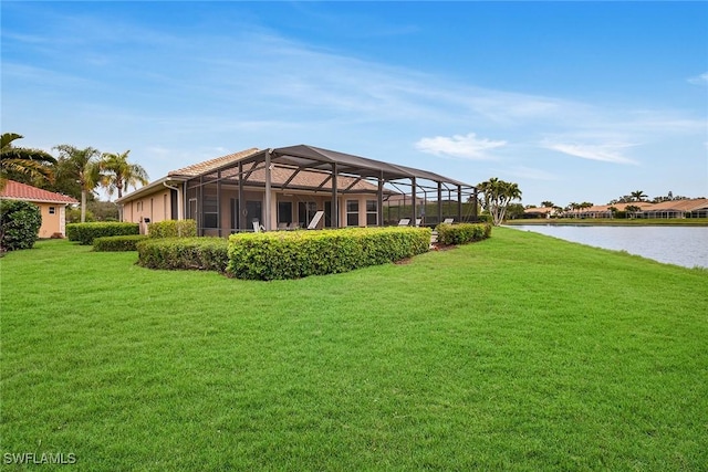 view of yard featuring a water view and glass enclosure