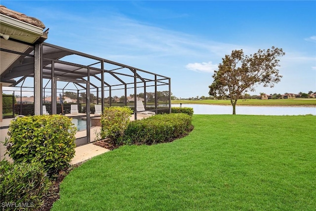 view of yard with a water view and glass enclosure