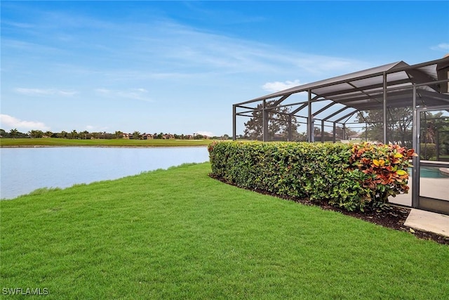 view of yard with a water view and a lanai