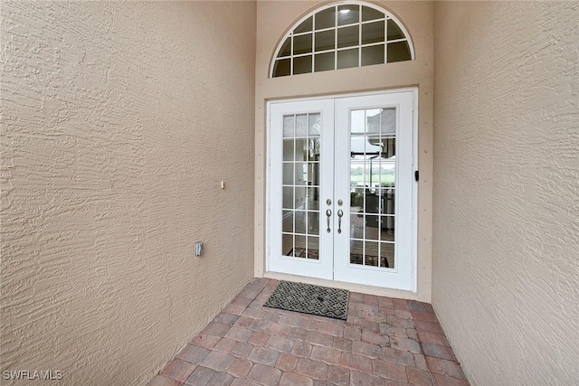 view of exterior entry featuring french doors