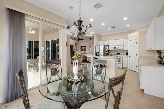 dining space featuring ornamental molding, light tile patterned floors, and a notable chandelier