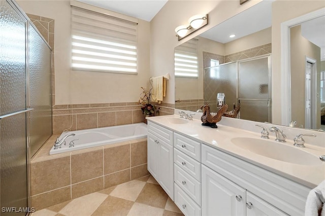 bathroom with vanity and shower with separate bathtub