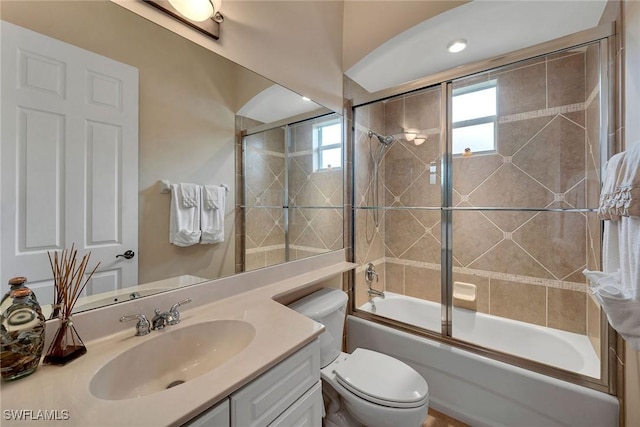 full bathroom with vanity, shower / bath combination with glass door, and toilet