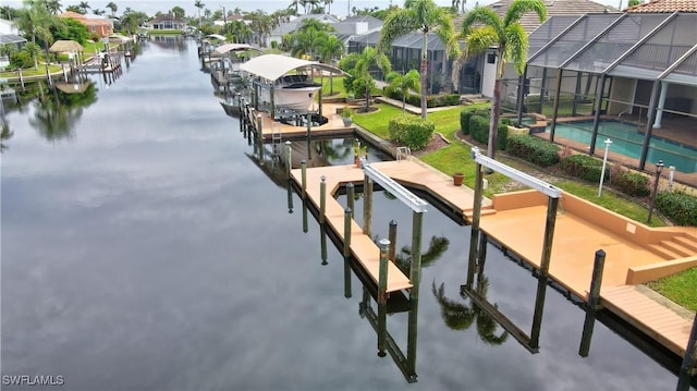 exterior space featuring a water view, a swimming pool, and a boat dock