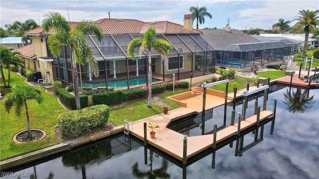 dock area featuring a patio area, a water view, and glass enclosure