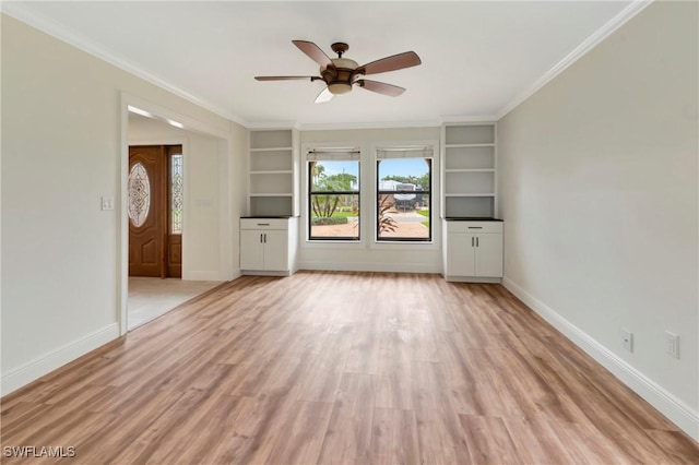 unfurnished living room with crown molding, built in shelves, ceiling fan, and light hardwood / wood-style flooring