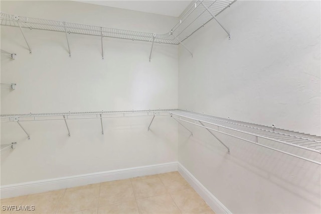 spacious closet featuring light tile patterned floors