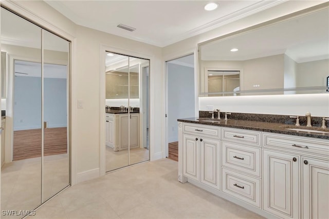 bathroom with crown molding and vanity