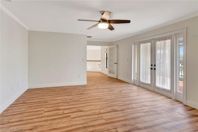 unfurnished room with ornamental molding, french doors, and light wood-type flooring