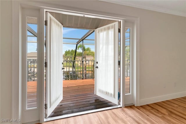 entryway featuring ornamental molding and light hardwood / wood-style floors