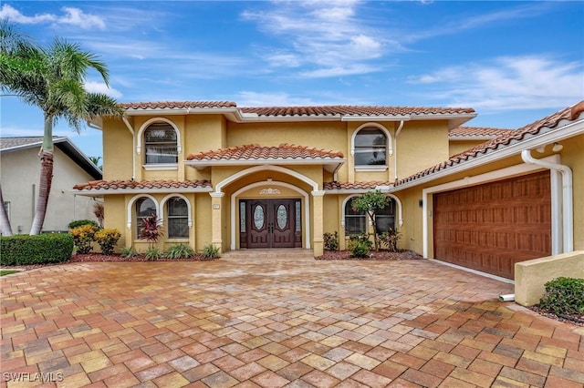 mediterranean / spanish-style house featuring a garage