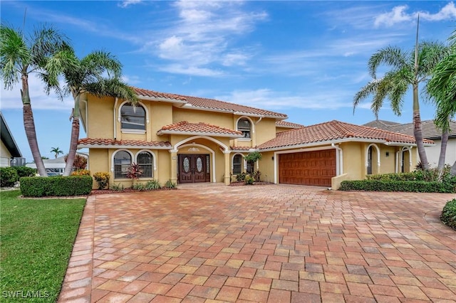 mediterranean / spanish home with a garage