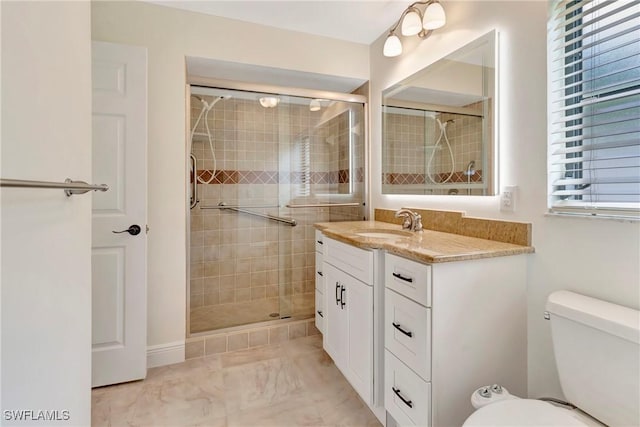 bathroom with vanity, toilet, and an enclosed shower