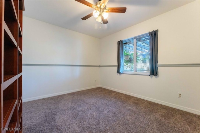 carpeted empty room with baseboards and a ceiling fan