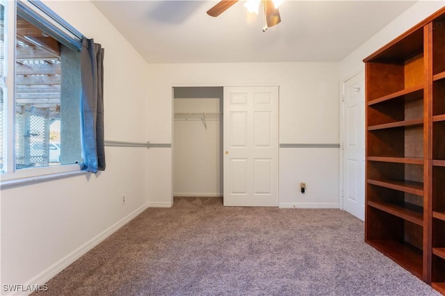 unfurnished bedroom featuring ceiling fan, carpet floors, a closet, and baseboards