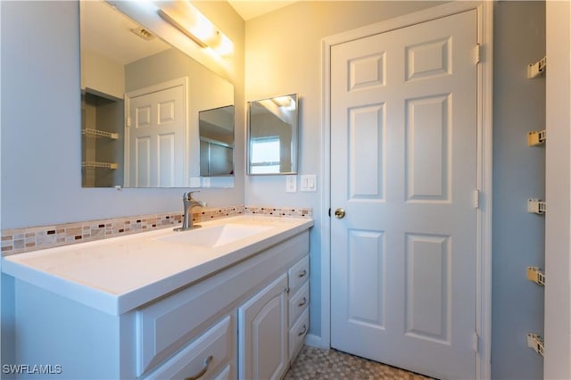 bathroom featuring decorative backsplash and vanity