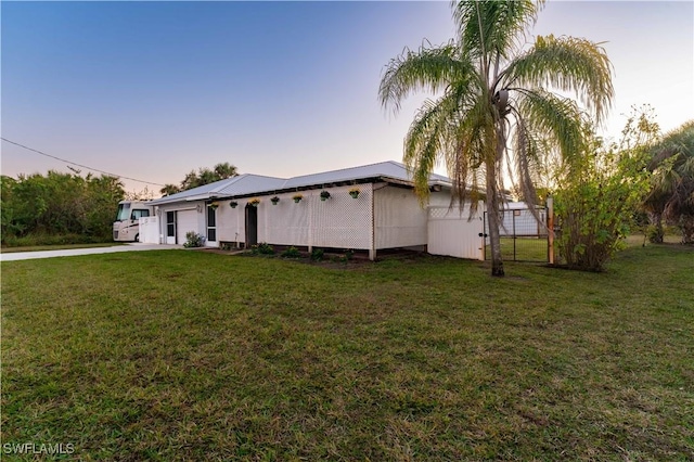 exterior space with a gate and a front lawn