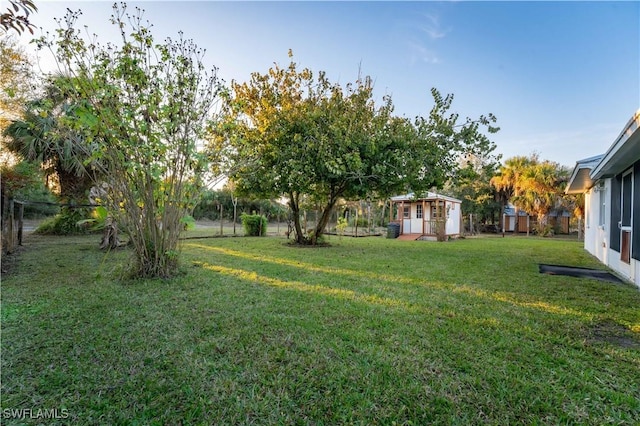 view of yard with an outbuilding and a fenced backyard