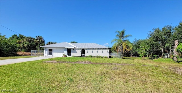 3054 NE Beechwood Cir, Labelle, FL 33935 - ranch-style house with concrete driveway, a front yard, a garage, and fence