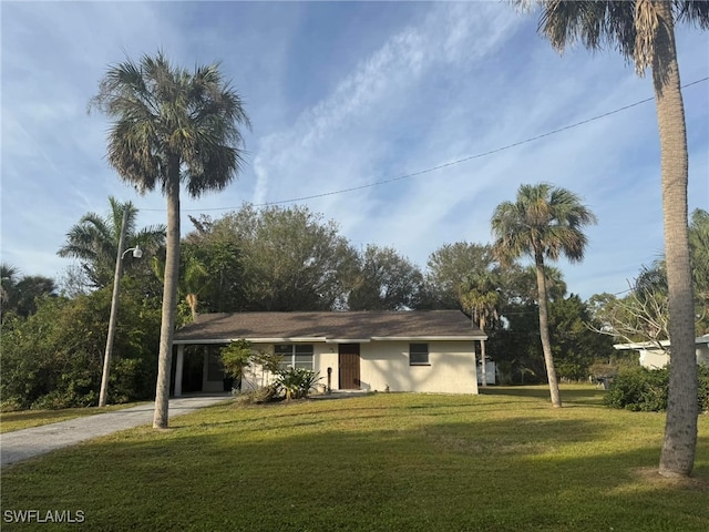 ranch-style house with a front yard and a carport