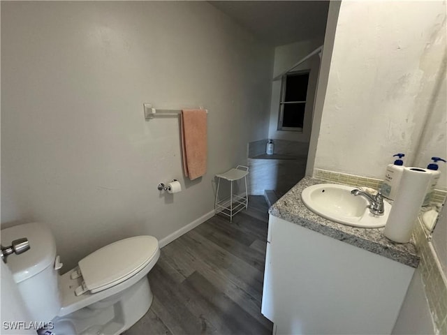 bathroom featuring hardwood / wood-style flooring, vanity, and toilet