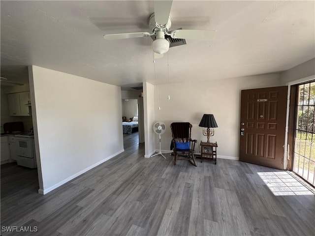 sitting room with wood-type flooring and ceiling fan