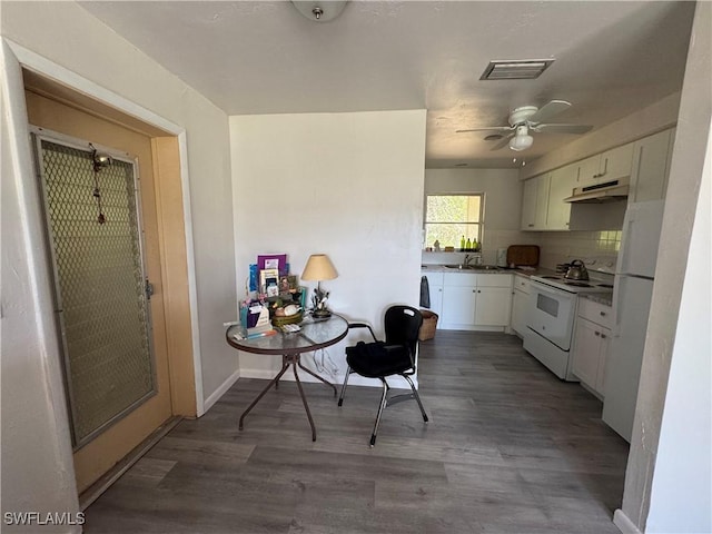 kitchen with white cabinets, wood-type flooring, sink, and white range with electric stovetop