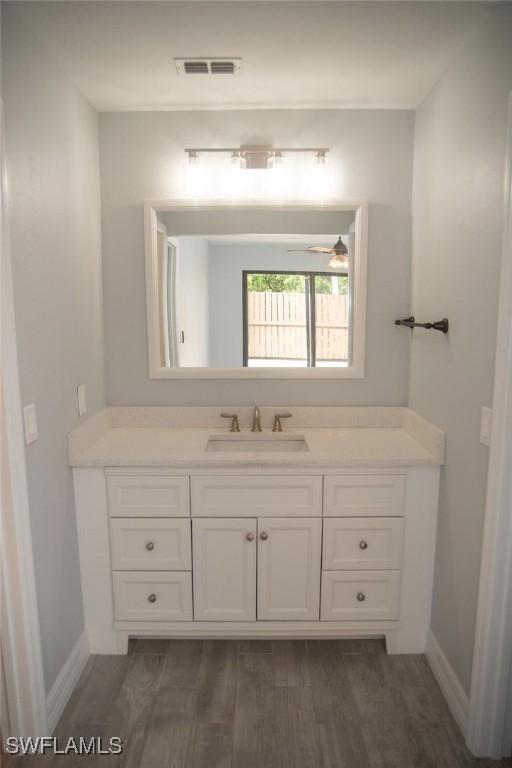 17291 Timber Oak Ln, Fort Myers, FL 33908 - bathroom featuring vanity, hardwood / wood-style floors, and ceiling fan