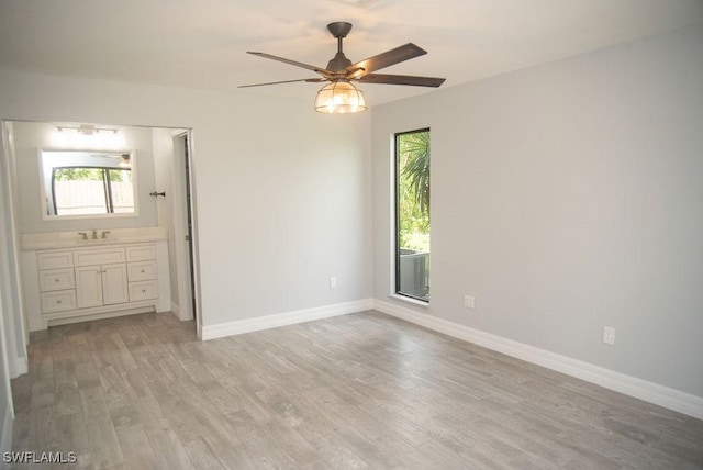 17291 Timber Oak Ln, Fort Myers, FL 33908 - unfurnished bedroom featuring ceiling fan, ensuite bathroom, and light hardwood / wood-style floors