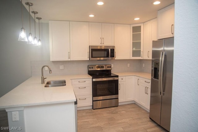 17291 Timber Oak Ln, Fort Myers, FL 33908 - kitchen with sink, light wood-type flooring, white cabinets, and appliances with stainless steel finishes