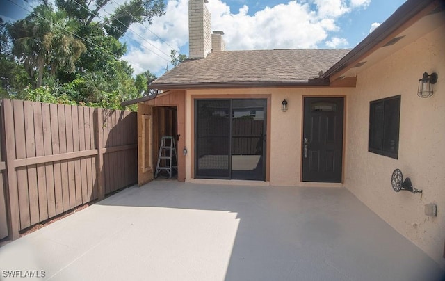 entrance to property featuring a patio