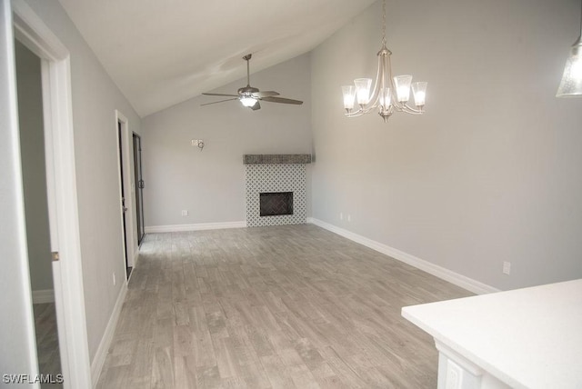 17291 Timber Oak Ln, Fort Myers, FL 33908 - unfurnished living room featuring a tile fireplace, high vaulted ceiling, ceiling fan, and light wood-type flooring