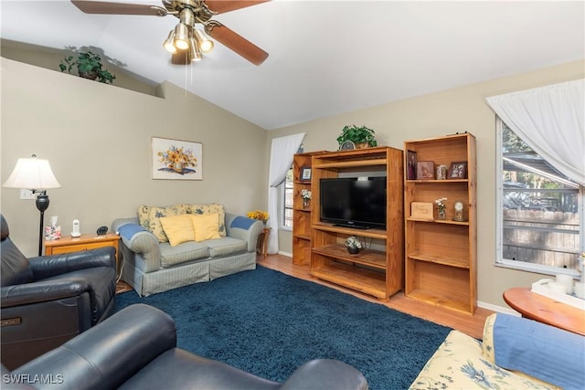 living room with lofted ceiling, hardwood / wood-style floors, and ceiling fan